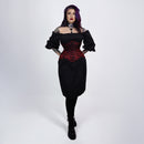 Woman wearing a black dress with a red corset top on a white background