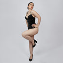 Model wearing black PVC underbust corset from side angle showing hourglass silhouette and hook and eye closure -- Daphne by Corsets Island